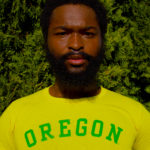 Jalen in a bright yellow Oregon Ducks shirt with 'Oregon' in bright green on the front