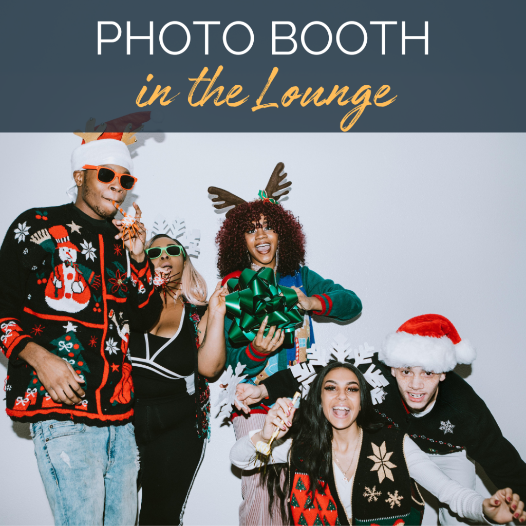 Image of a group a people in holiday outfits in a photo booth. Text reads: Photo booth in the Community Hall